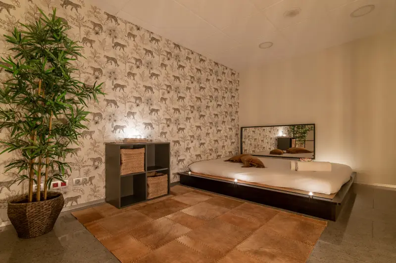 Massage room with a large bed and mirror